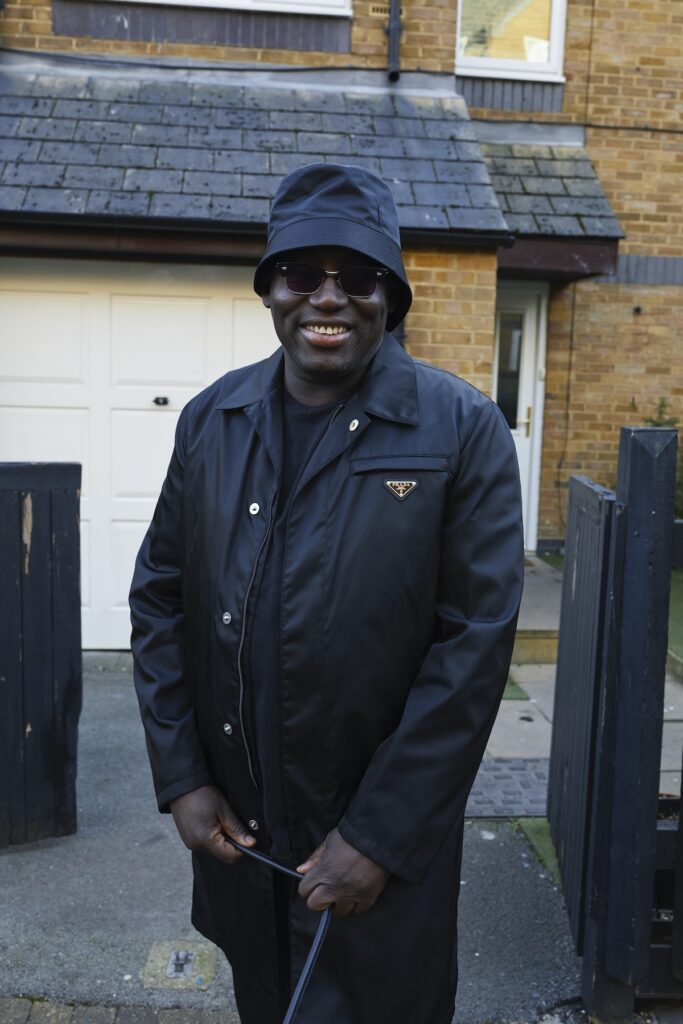 Edward Enninful smiles outside his childhood home in London's Ladbroke Grove