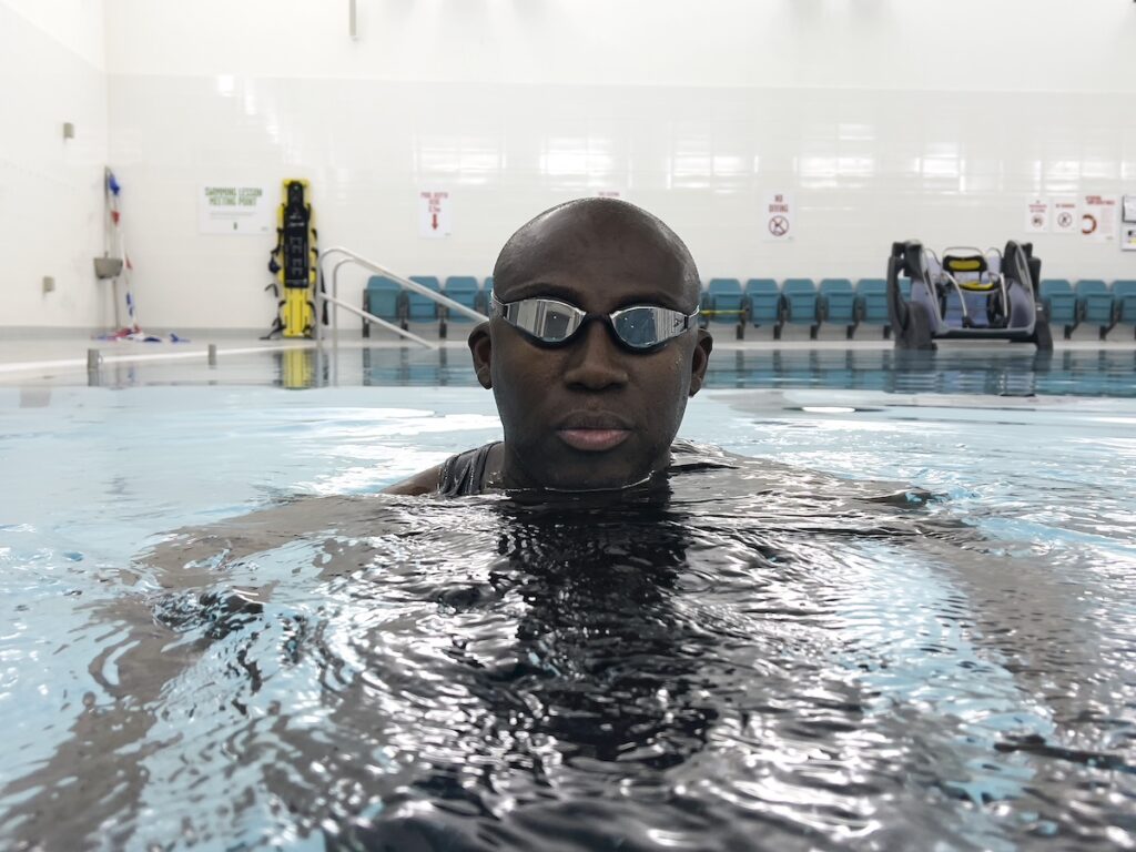 Edward Enninful wears goggles in a swimming pool in London