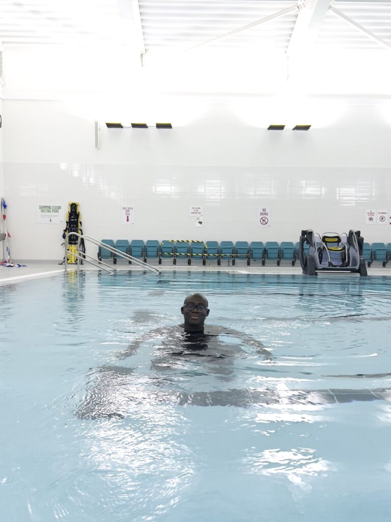 Edward Enninful floats in a swimming pool in his neighbourhood of Ladbroke Grove London, captured by Juergen Teller