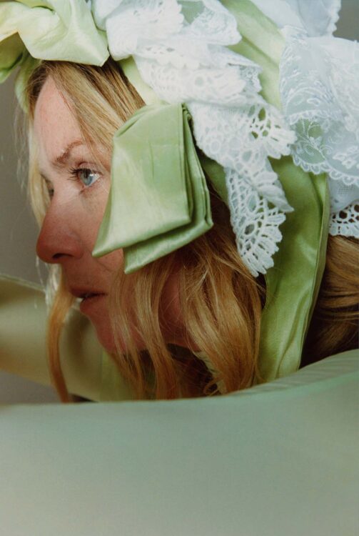 Side profile of Róisín Murphy wearing a green silk bonnet