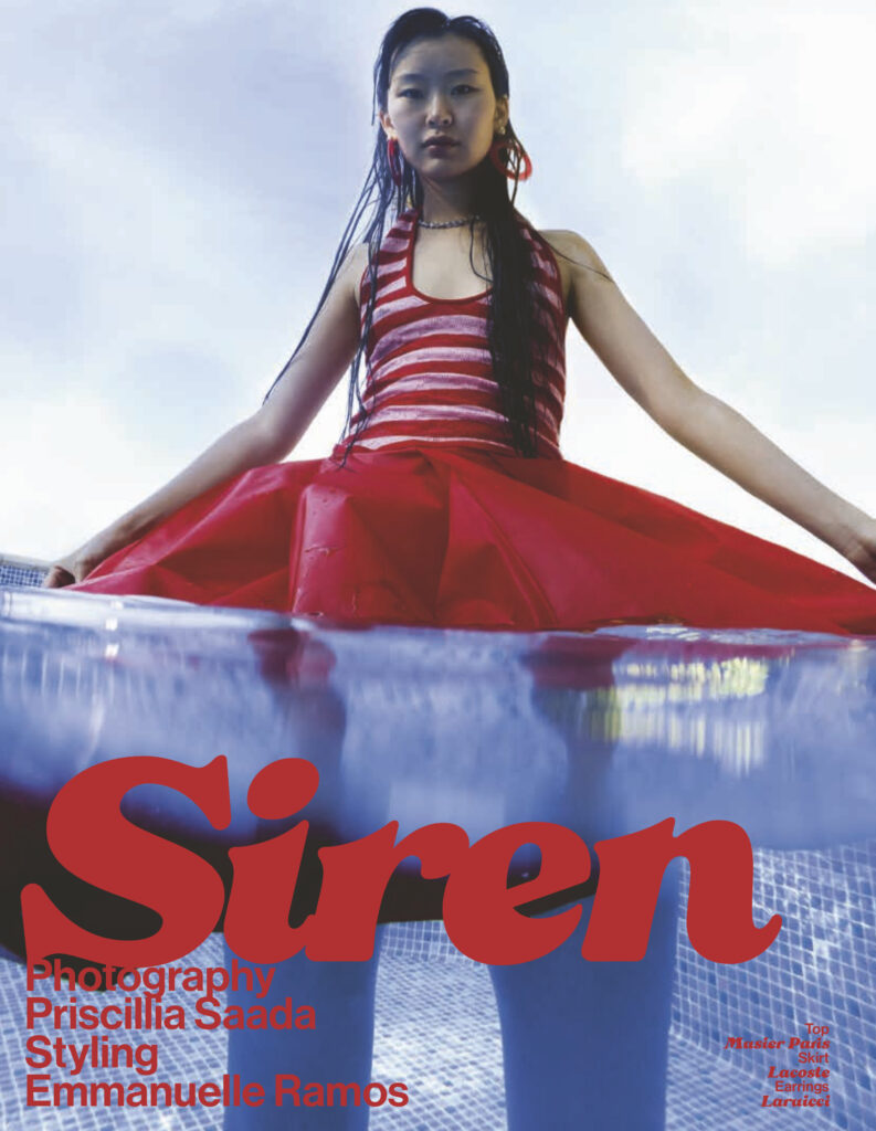 Model wears red top and skirt submerged in water