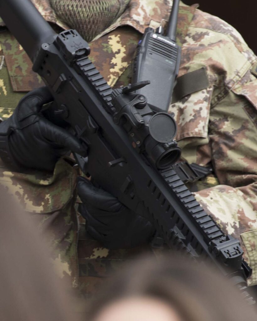 Close-up of a khaki uniform and gun