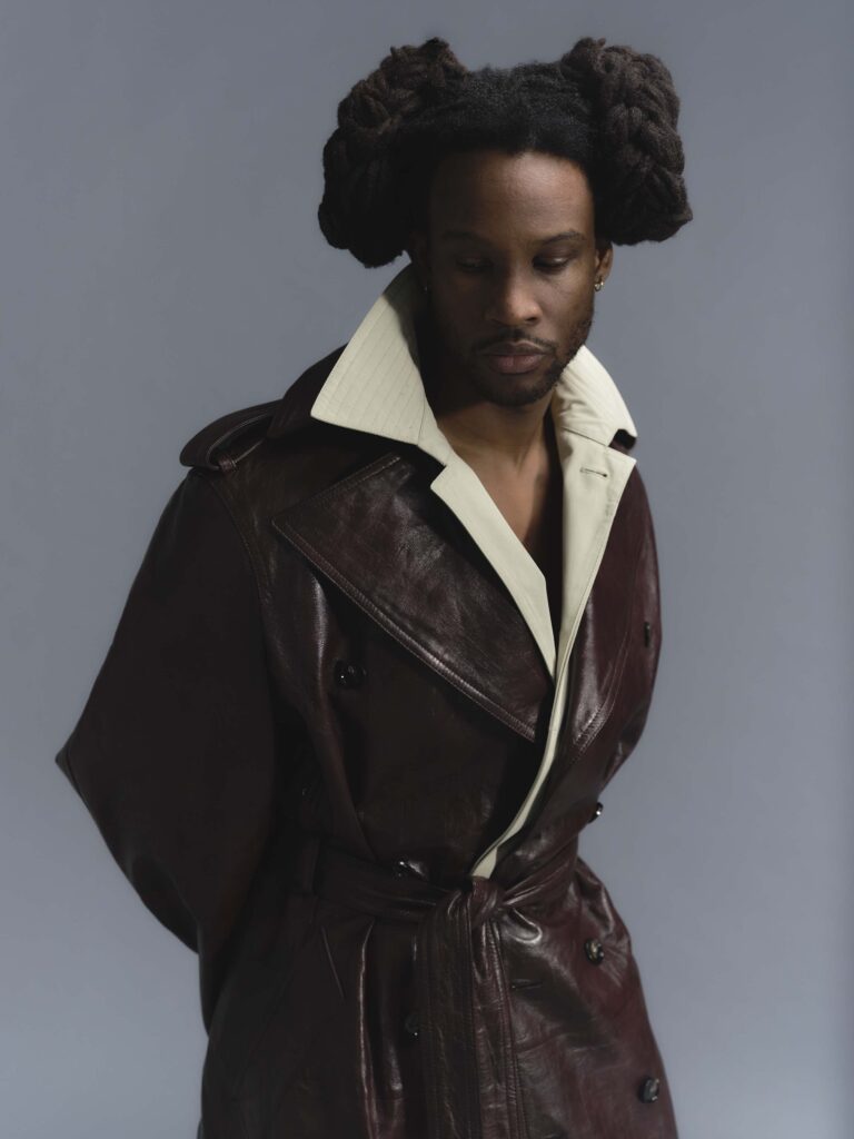 Akinola in layered Bottega jackets with hair in bunches